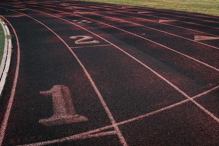 Empty Running Track Lanes with Numbers and White Lines