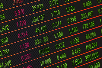 Close-up of digital stock market ticker board with financial data