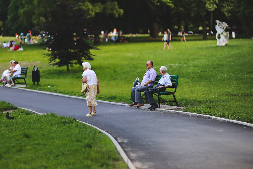 Senior citizens relaxing on park bench