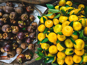 Fresh Mangosteen and Tangerines in Woven Baskets