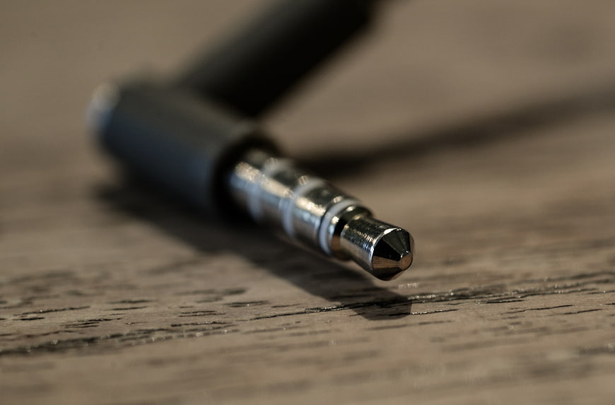 Close-up of 3.5mm audio jack on wooden surface