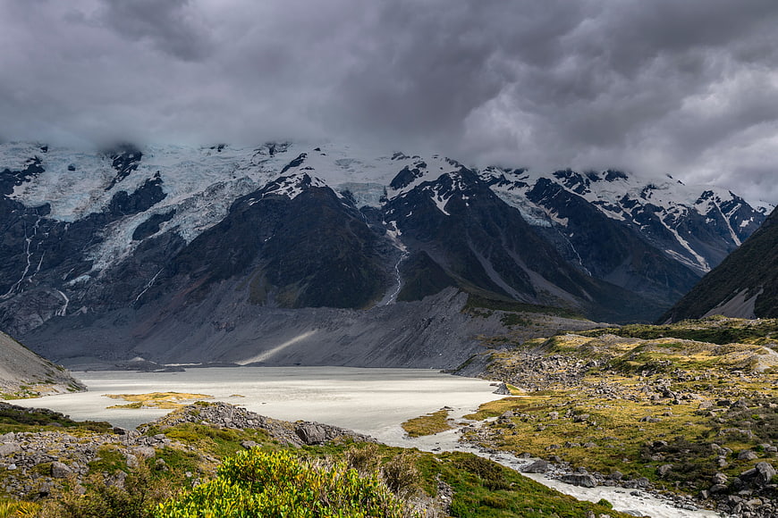 Dramatic Glacial Landscape with Snow-Capped Mountains and Overcast Sky
