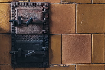 Vintage Cast Iron Stove Door on Yellow Brick Wall