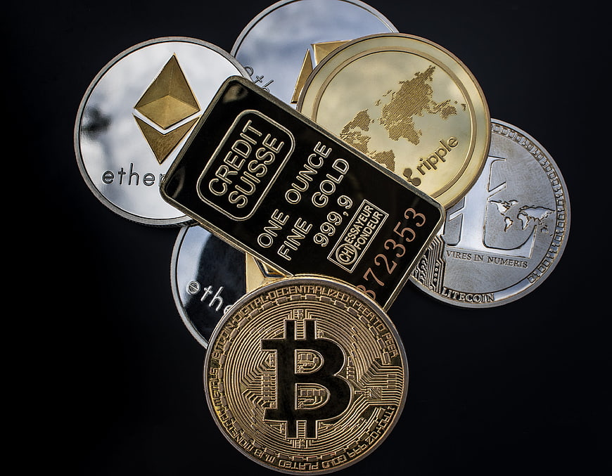 Physical Cryptocurrency Coins And Gold Bar On Black Background