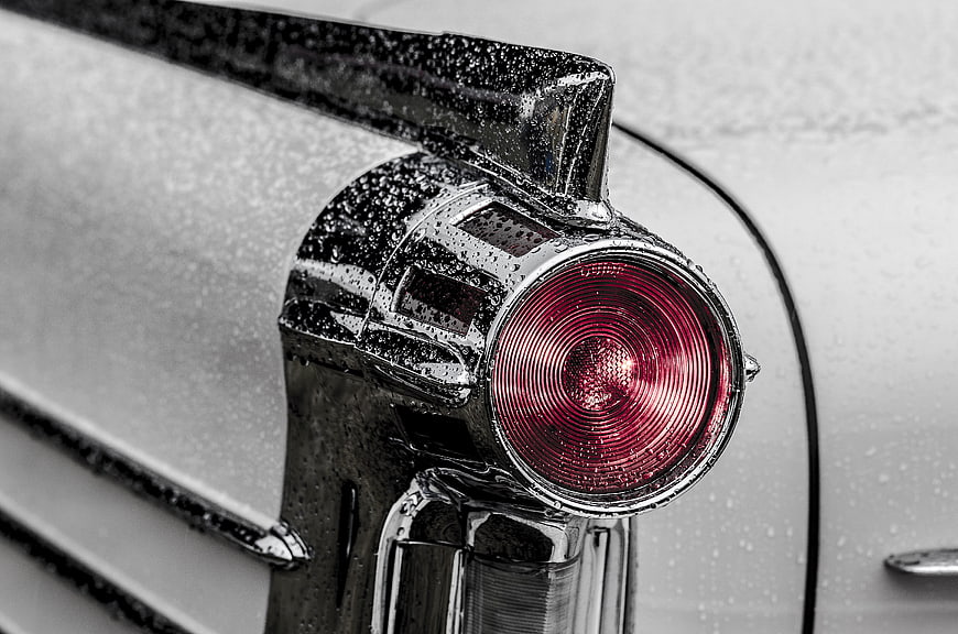 Close-up of vintage car tail light with raindrops
