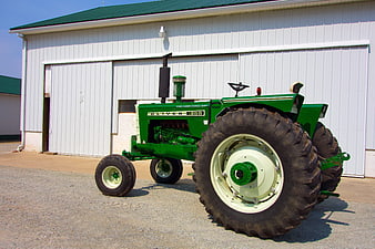 Vintage Green Oliver 1965 Tractor in Front of White Barn