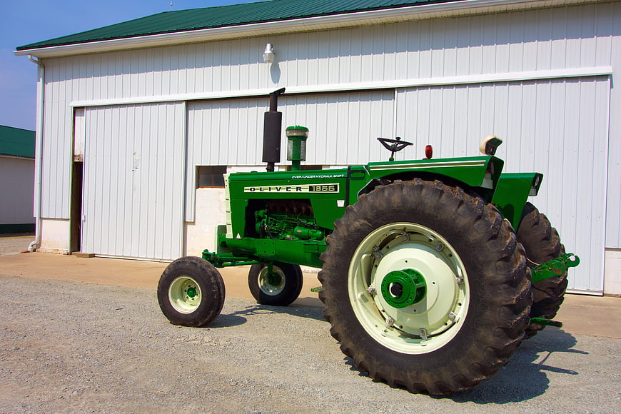Vintage Green Oliver 1965 Tractor in Front of White Barn