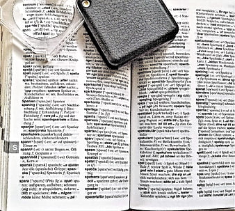 Open Swedish-German Dictionary with Magnifying Glass and Leather Wallet