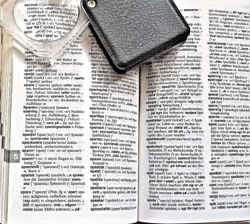Open Swedish-German Dictionary with Magnifying Glass and Leather Wallet