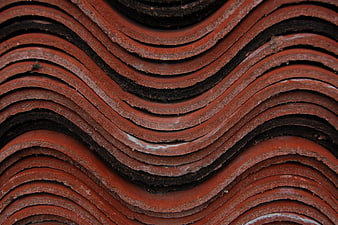 Close-up texture of stacked red terracotta roof tiles