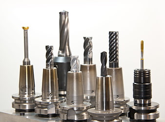 Assortment of CNC milling cutters and drill bits in collets