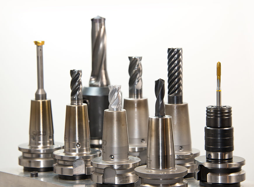 Assortment of CNC milling cutters and drill bits in collets