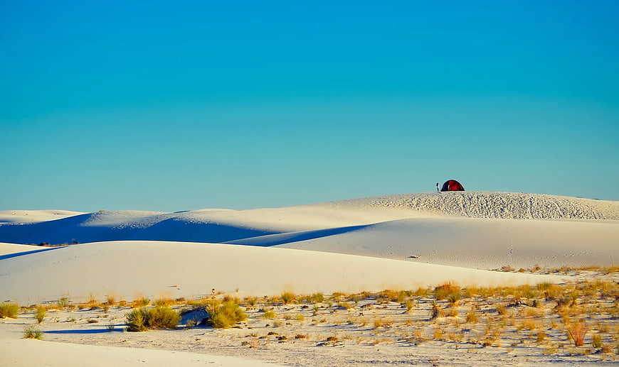 Red Tent on White Sand Dunes Under Blue Sky
