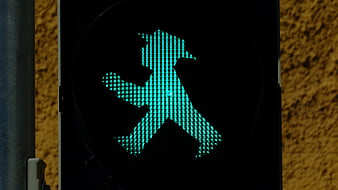 Green pedestrian traffic light with East German man silhouette