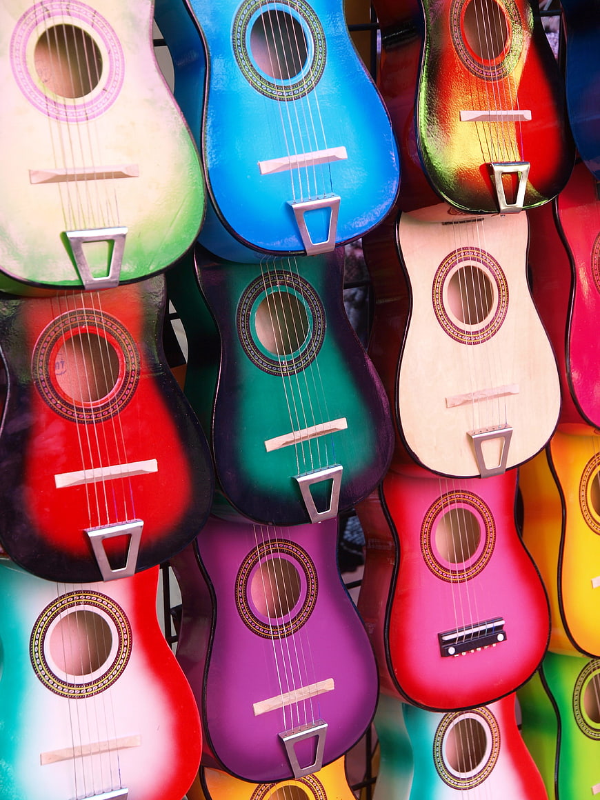 Colorful Miniature Guitars Hanging in a Market Display