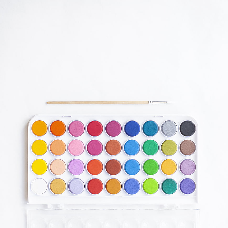 Top View of Colorful Watercolor Paint Set with Brush