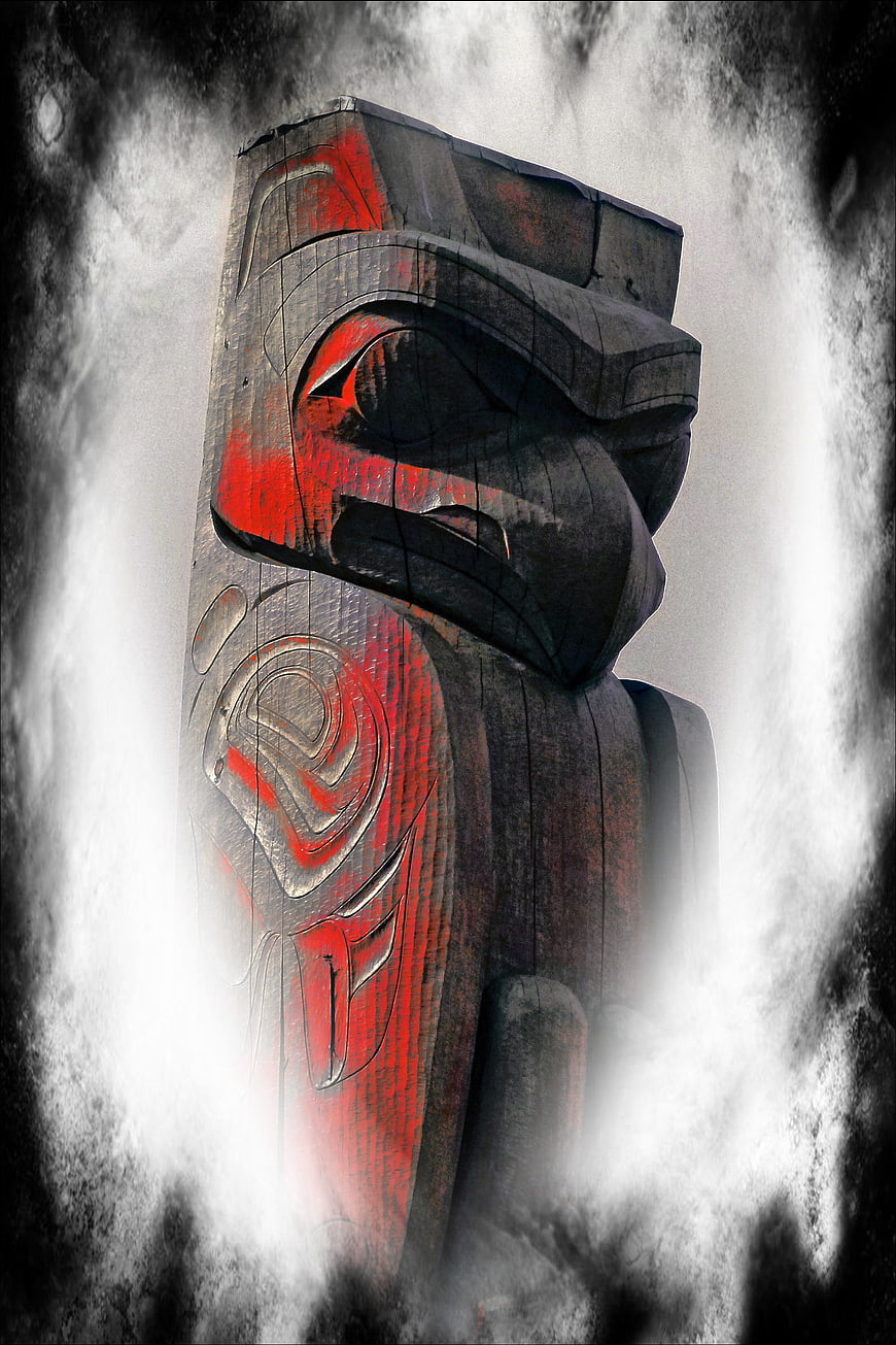 Dramatic Indigenous Totem Pole Sculpture in Misty Fog