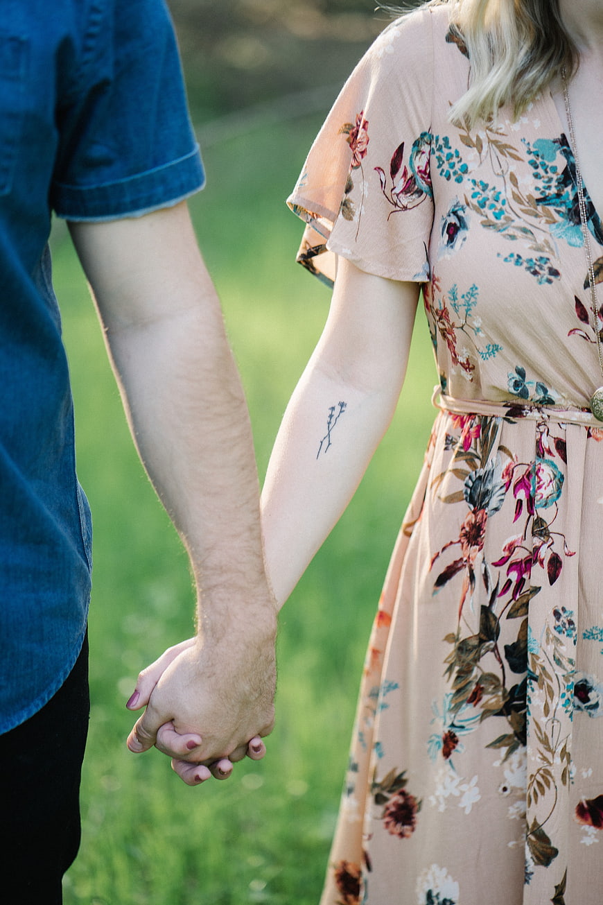 Couple Holding Hands in Floral Dress and Denim Shirt