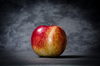 Single Red Apple on Dark Textured Background