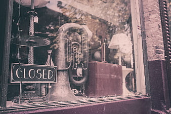 Vintage shop window display with closed sign and tuba