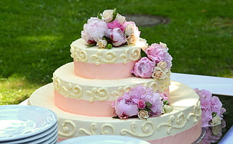 Three-Tier Wedding Cake with Pink Peonies and Cream Frosting