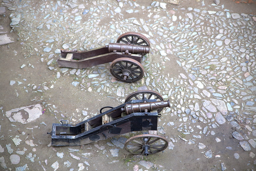 Two antique cannons on cobblestone ground