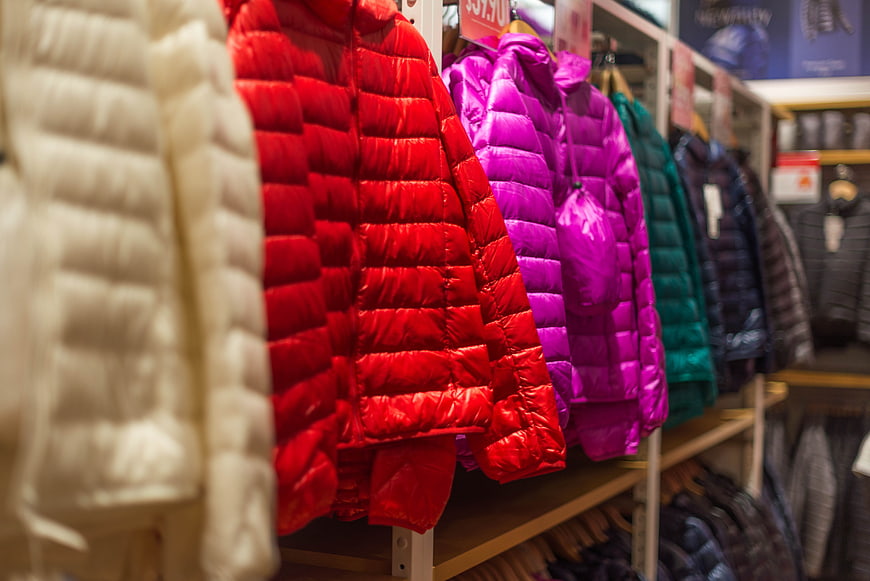 Colorful Down Jackets Hanging in Retail Clothing Store