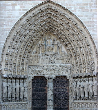 Gothic church portal with intricate stone carvings and religious sculptures