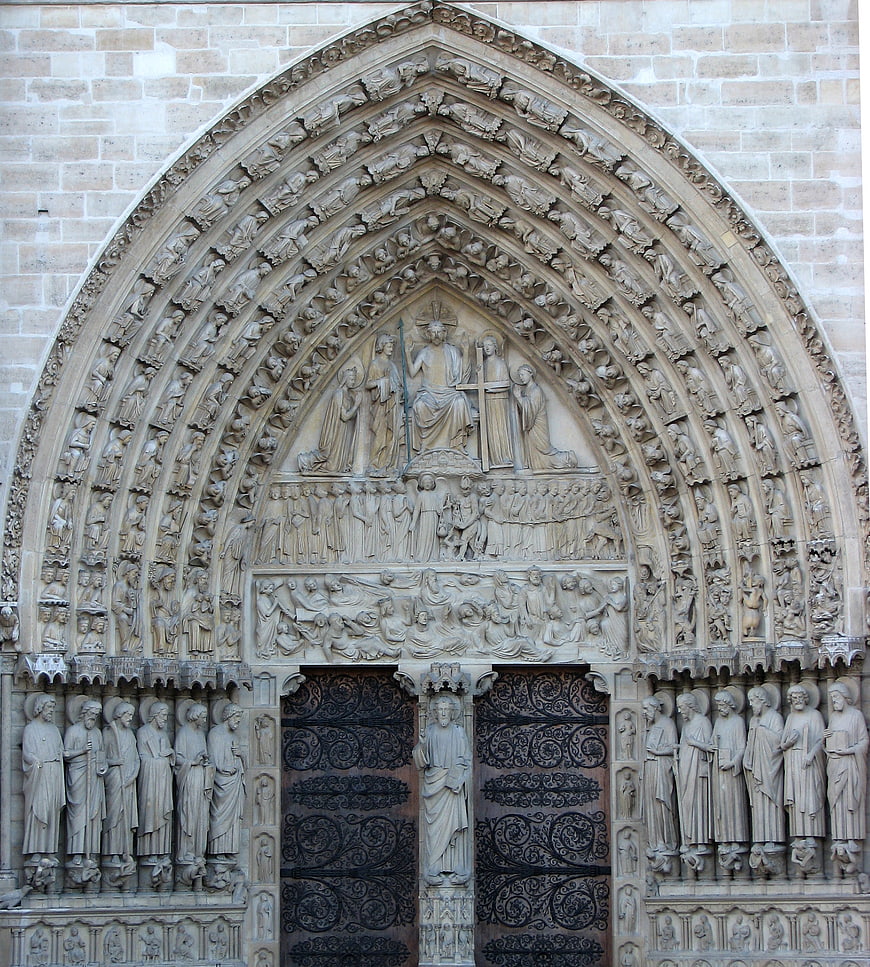 Gothic church portal with intricate stone carvings and religious sculptures