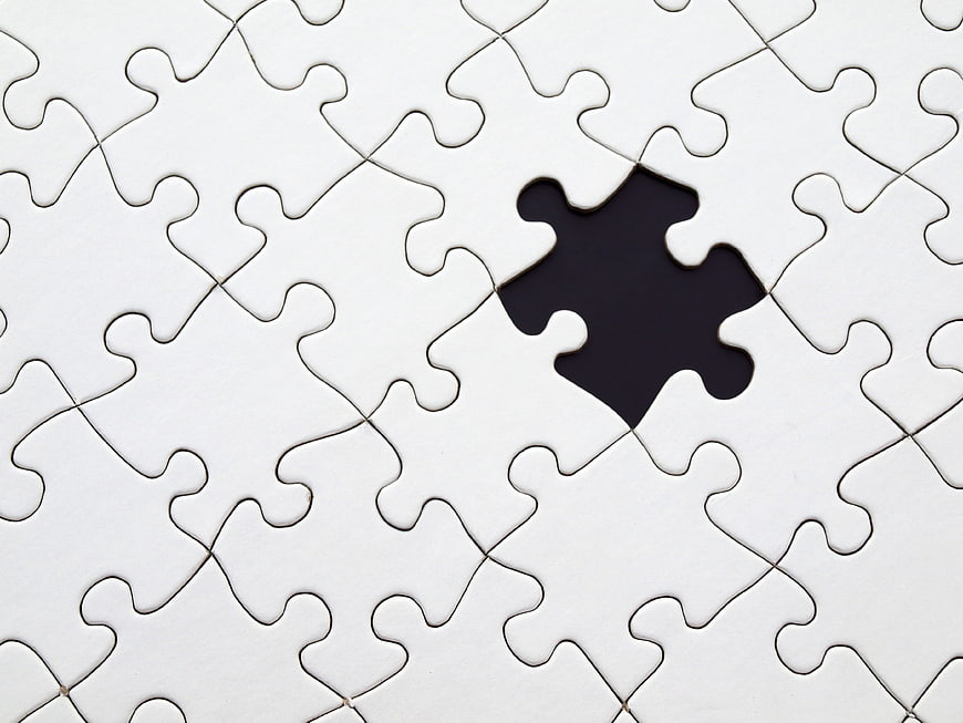 White jigsaw puzzle with missing piece hole