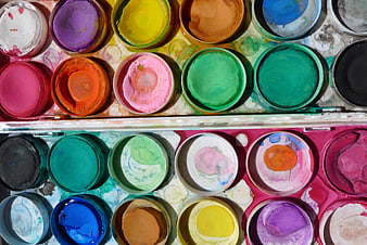 Top view of colorful watercolor paint palette with mixed pigments