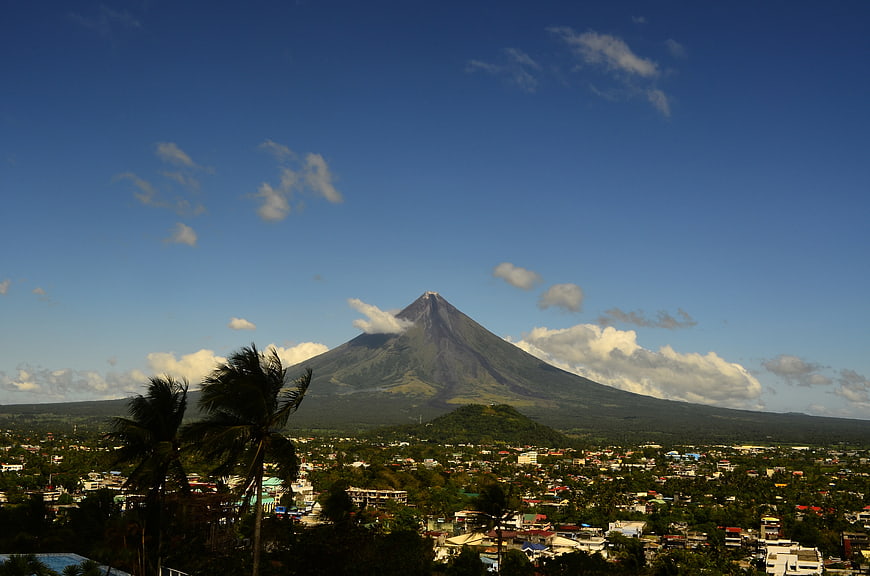 Mayon Volcano in Albay, Philippines with tropical town and palm trees