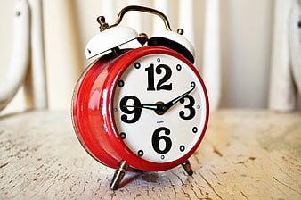 Vintage Red Alarm Clock on Rustic Wooden Table