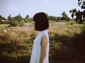 Woman in White Dress Standing in Field
