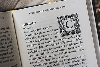 Open Book Page About Centaurs with Decorative Initial
