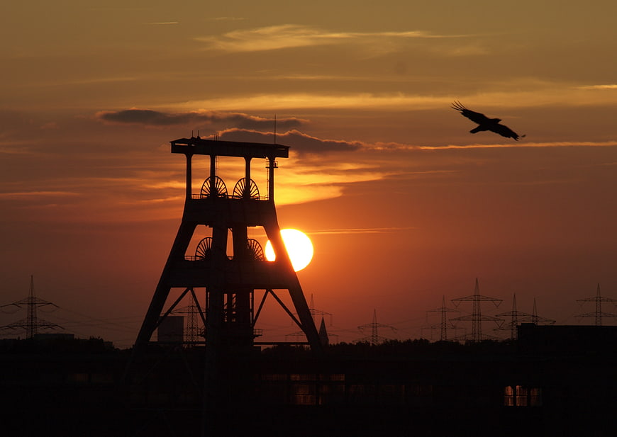 Silhouette of Coal Mine Headframe and Bird at Sunset