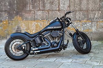 Black Harley-Davidson Custom Motorcycle Parked Against Stone Wall