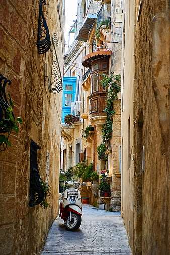 Narrow Mediterranean Alleyway with Parked Scooter and Historic Architecture
