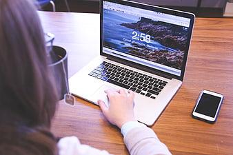 Woman using laptop in modern office workspace
