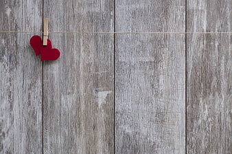 Red Felt Hearts on Clothespin Against Rustic Wood Background