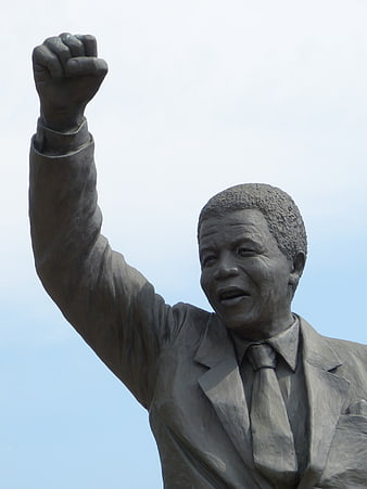 Nelson Mandela Statue Raising Fist Against Blue Sky