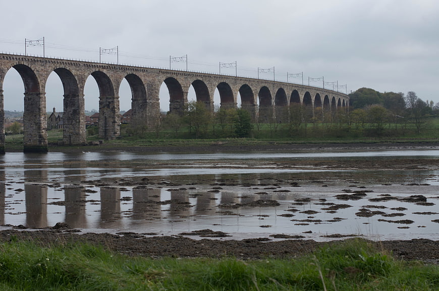 Stone Railway Viaduct Over River Estuary at Low Tide