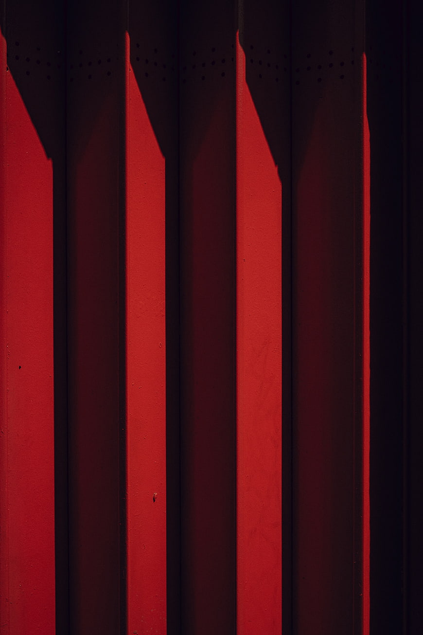Abstract Red Corrugated Metal Wall with Shadows