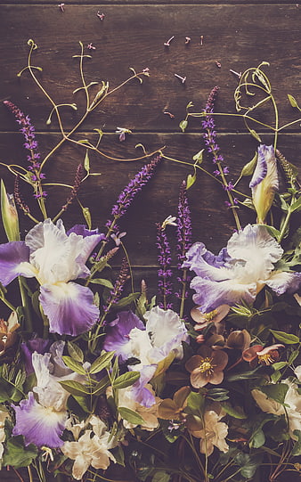 Rustic Flat Lay of Purple Irises and Wildflowers on Wood