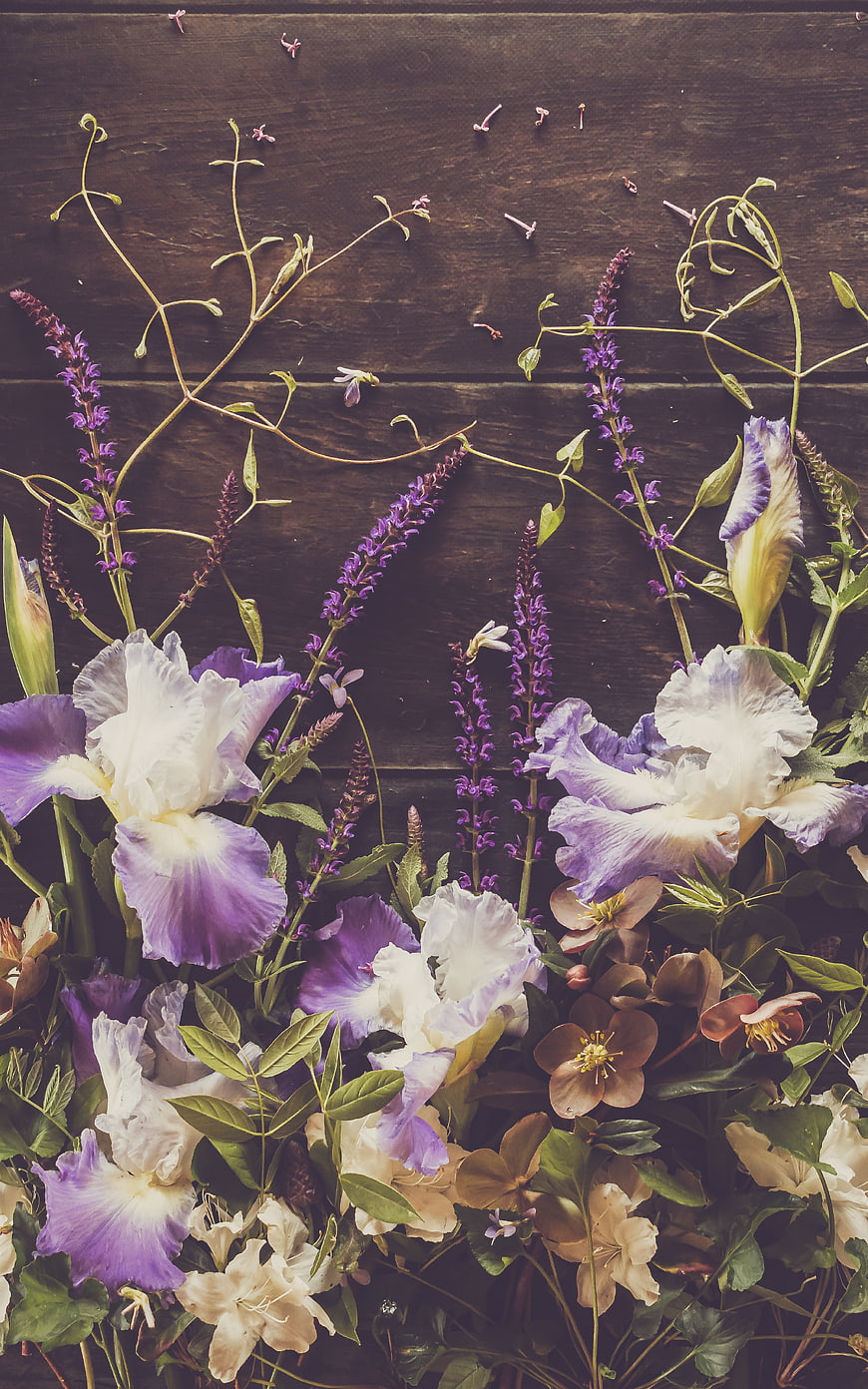 Rustic Flat Lay of Purple Irises and Wildflowers on Wood