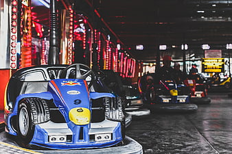 Blue bumper car at indoor amusement park with neon lights