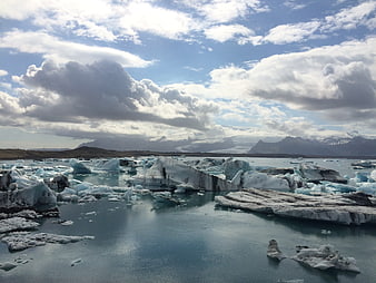 Icelandic Glacier Lagoon with Floating Icebergs and Mountains