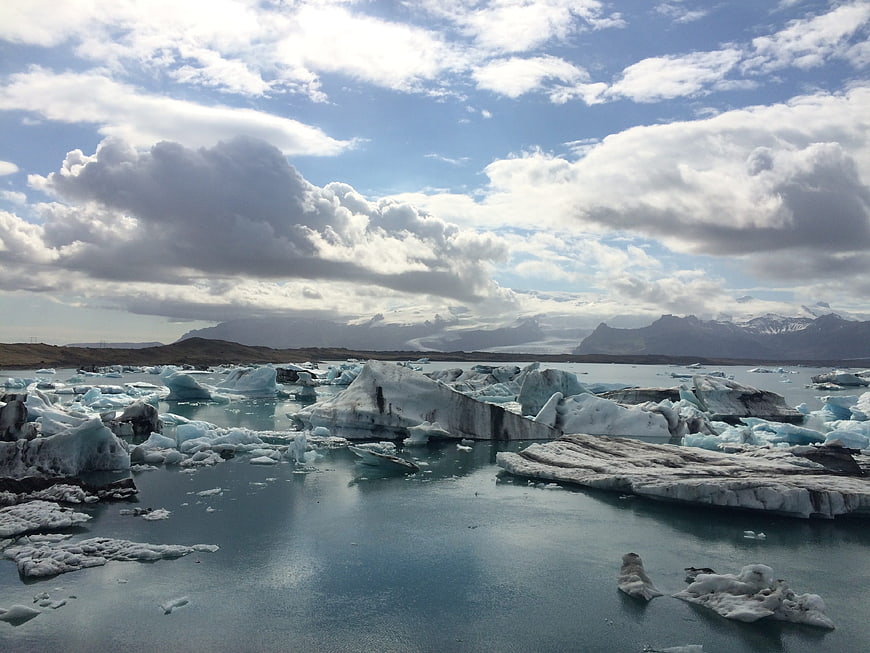 Icelandic Glacier Lagoon with Floating Icebergs and Mountains