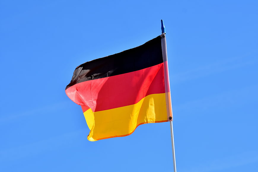 German Flag Waving Against Clear Blue Sky