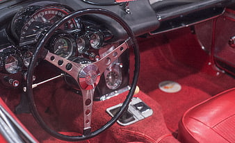 Vintage red car interior with classic steering wheel and dashboard
